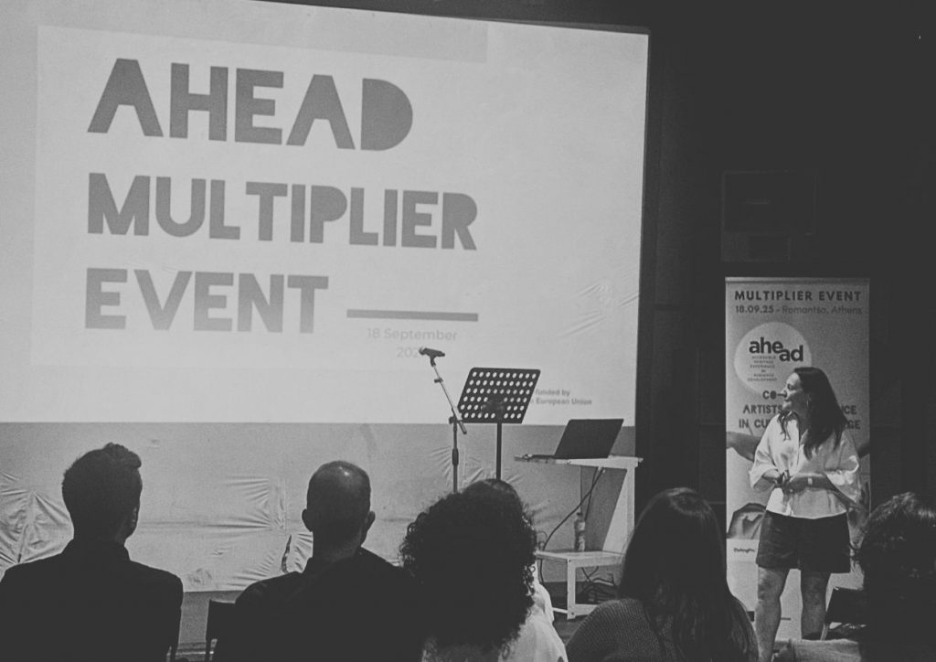 Woman presenting in front of screen and audience