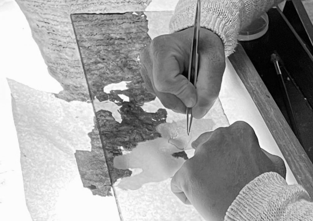 A conservator at work conserving paper. Credit: TARII (Amanda Long)