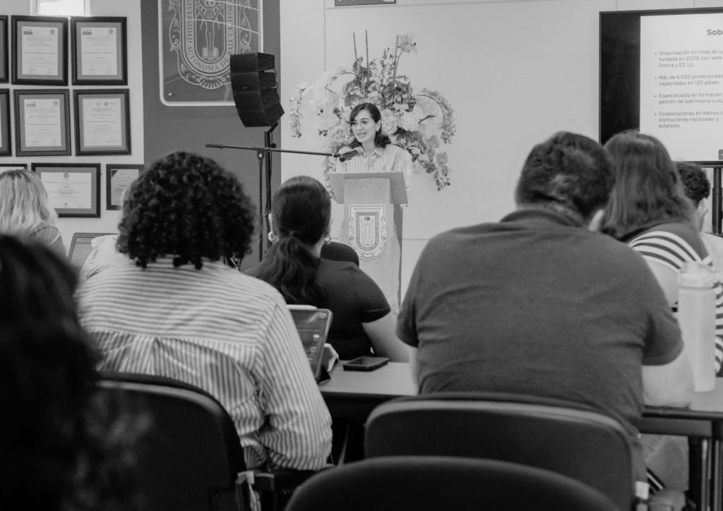 HERITΛGE's Denise Navarro in a room addressing students sitting at desks