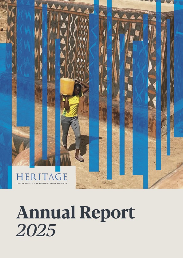 Annual Report 2025 cover showing a woman carrying a bucket walking in front of a building of traditional african architecture