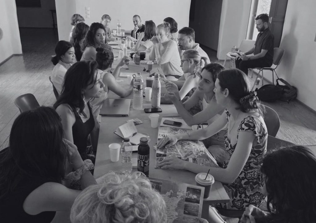 A group of trainees around a table discussing