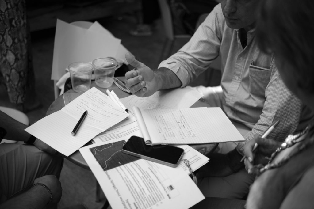 hands working on a table full of study materials